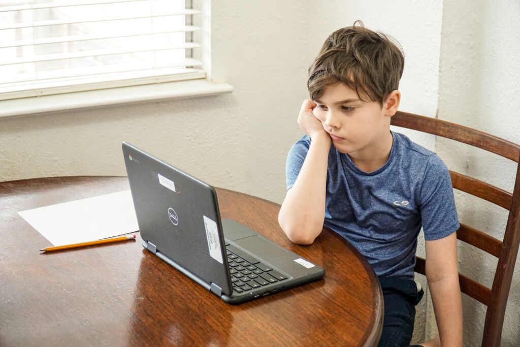 boy at computer looking dismayed