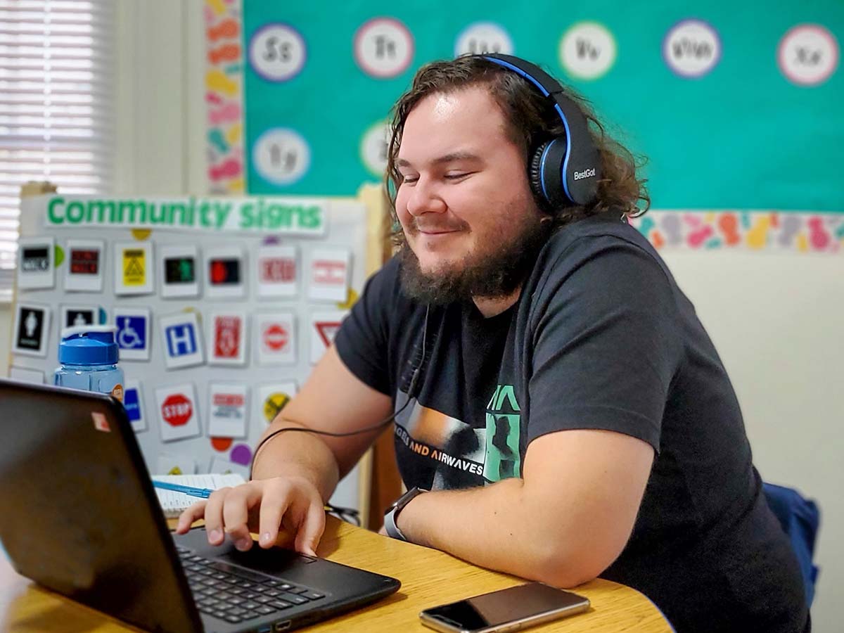 high school student studying on his computer