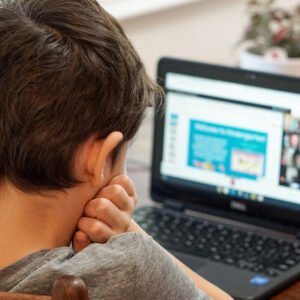 photo of a child working on a laptop