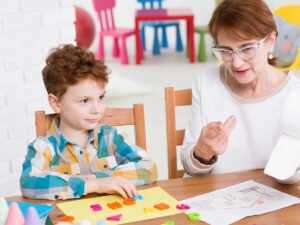 a teacher happily working one on one with a child with autism