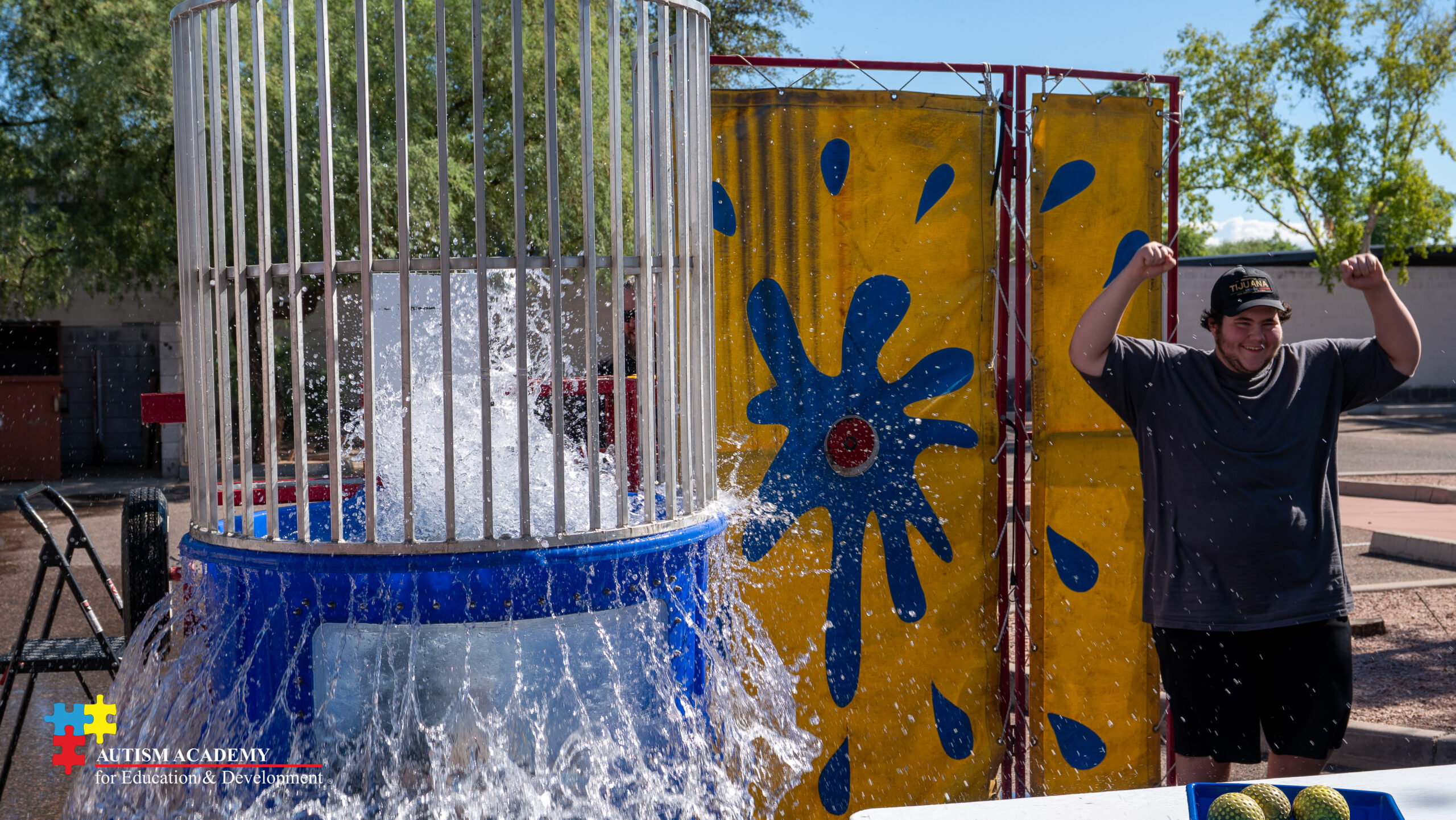 student poses with another student in dunk tank